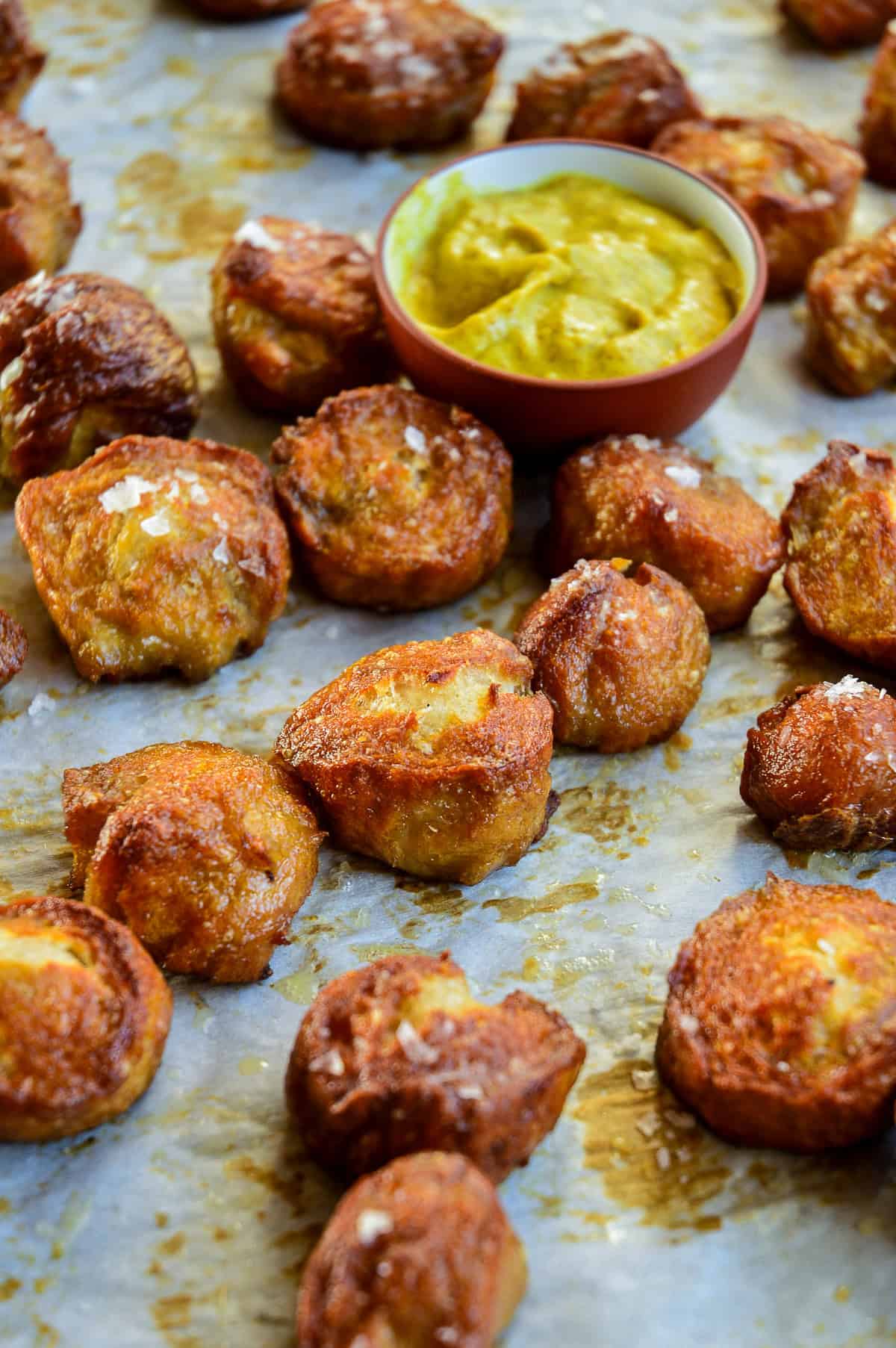 soft pretzel nuggets on baking sheet with mustard