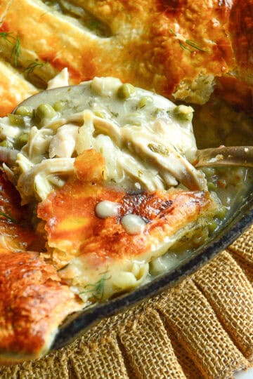spoonful of chicken pot pie with puff pastry in skillet