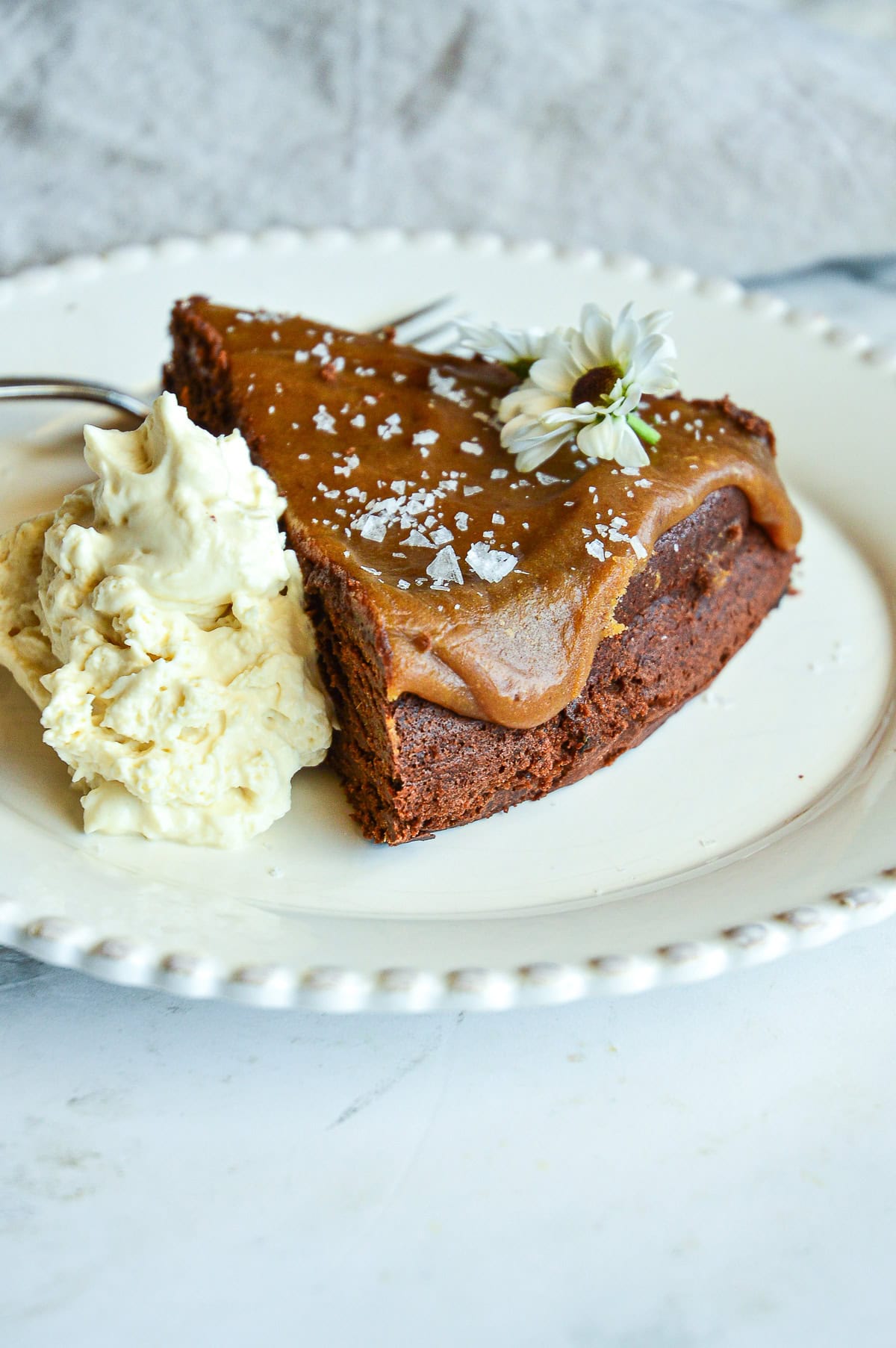 slice of chocolate date cake with whipped cream