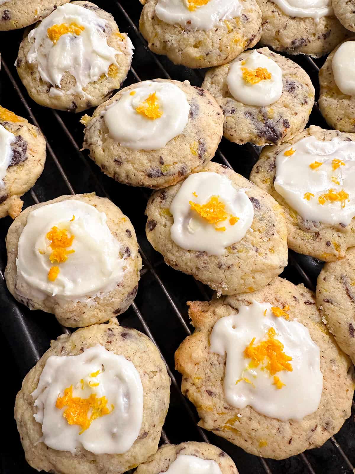 frosted orange cookies on wire rack