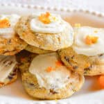 orange cookies with frosting on white plate