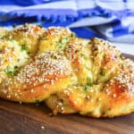 easy challah recipe with scallions on wood cutting board