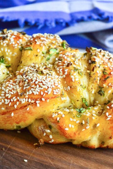 easy challah recipe with scallions on wood cutting board