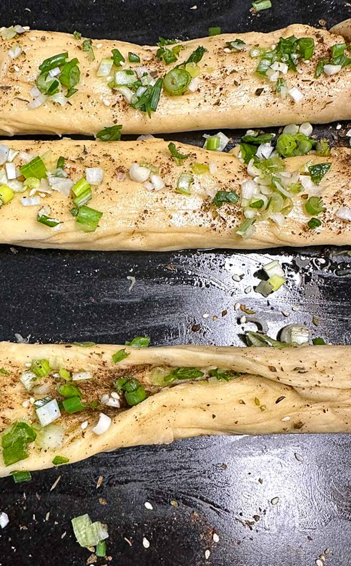 making strands of challah with scallions