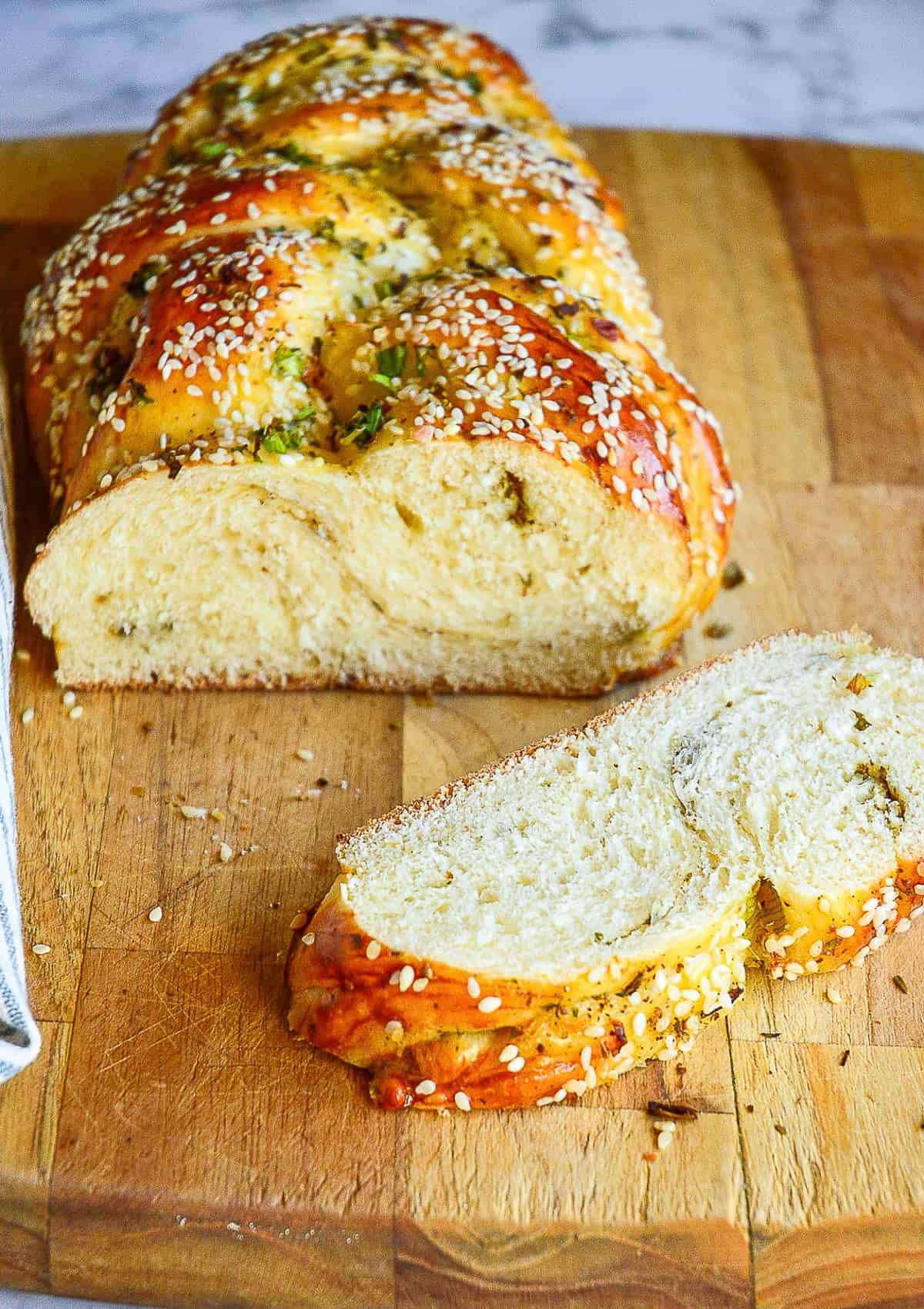 sliced open challah recipe with slice of challah on cutting board
