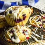 glazed bluberry muffin on top of a muffin tin